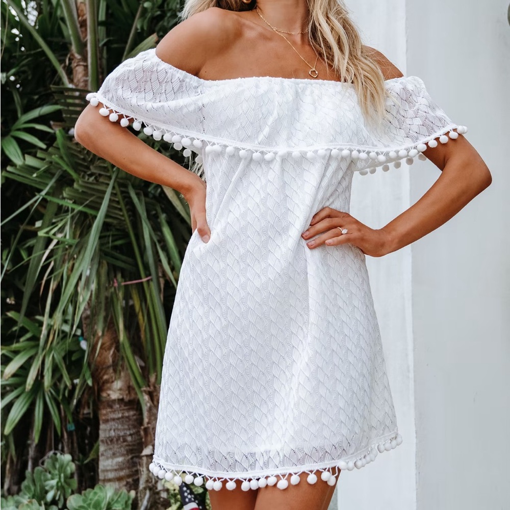 Brand new with tags, Size M. White strapless dress with Pom Poms